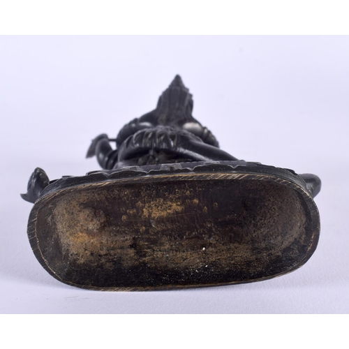 335 - A 19TH CENTURY TIBETAN BRONZE FIGURE OF A BUDDHISTIC BEAST modelled with consort. 14 cm x 6.5 cm.