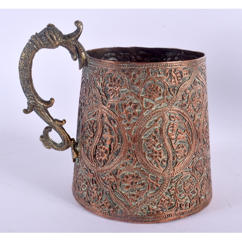 340 - AN UNUSUAL 19TH CENTURY MIDDLE EASTERN MIXED METAL MUG decorated with scrolling foliage and vines. 1... 