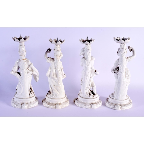 36 - A SET OF FOUR EARLY 20TH CENTURY EUROPEAN BLANC DE CHINE FOUR SEASON CANDLESTICKS. 25 cm high. (4)