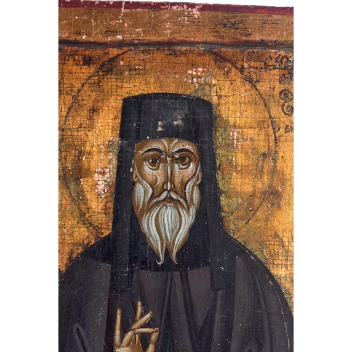 385 - AN ANTIQUE RUSSIAN POLYCHROMED WOOD ICON. 23 cm x 18 cm.