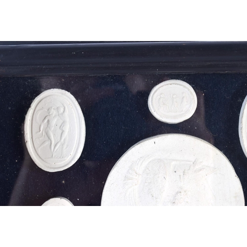 391 - A FRAMED SET OF EARLY 20TH CENTURY PLASTER INTAGLIO CAMEOS. 28 cm x 20 cm.