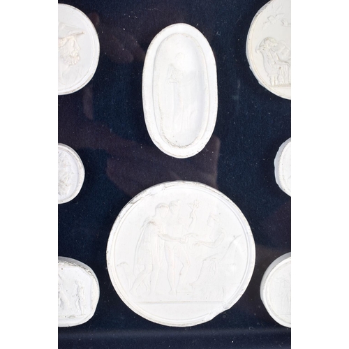 391 - A FRAMED SET OF EARLY 20TH CENTURY PLASTER INTAGLIO CAMEOS. 28 cm x 20 cm.