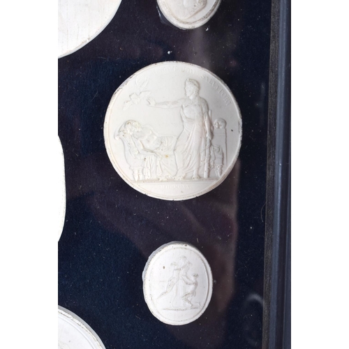 391 - A FRAMED SET OF EARLY 20TH CENTURY PLASTER INTAGLIO CAMEOS. 28 cm x 20 cm.