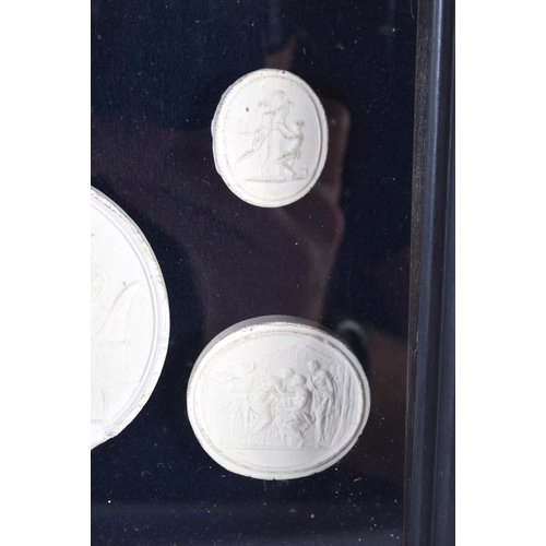 391 - A FRAMED SET OF EARLY 20TH CENTURY PLASTER INTAGLIO CAMEOS. 28 cm x 20 cm.