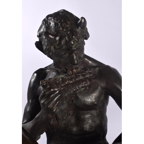 399 - A LARGE ART NOUVEAU BRONZED TERRACOTTA FIGURE OF PAN modelled with a nymph. 47 cm x 28 cm.