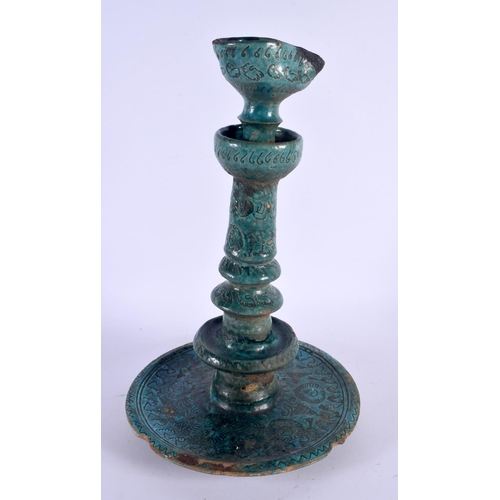 403 - A LARGE 17TH/18TH CENTURY PERSIAN TURQUOISE GLAZED OIL LAMP engraved with foliage and motifs. 38 cm ... 