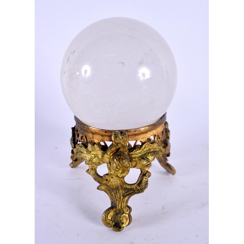 410 - AN ANTIQUE FRENCH ROCK CRYSTAL BALL upon a gilt metal stand. 12 cm x 8 cm.