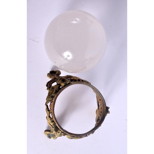 410 - AN ANTIQUE FRENCH ROCK CRYSTAL BALL upon a gilt metal stand. 12 cm x 8 cm.