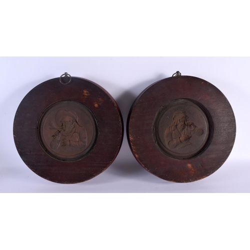 449 - A PAIR OF FRAMED 19TH CENTURY EUROPEAN COPPER PANELS within wooden frames. 27 cm diameter.