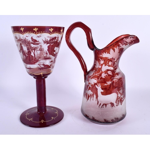 45 - A LARGE BOHEMIAN RUBY GLASS JUG together with a similar chalice Largest 25 cm high. (2)