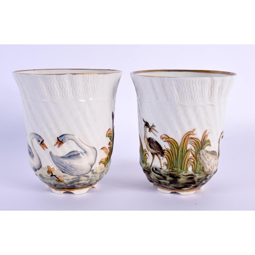 451 - A PAIR OF 19TH CENTURY ITALIAN PORCELAIN BEAKERS decorated in relief with birds in landscapes. 8 cm ... 