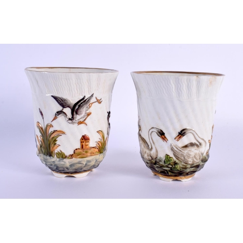 451 - A PAIR OF 19TH CENTURY ITALIAN PORCELAIN BEAKERS decorated in relief with birds in landscapes. 8 cm ... 