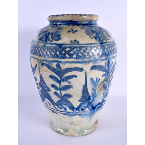 470 - AN EARLY MIDDLE EASTERN PERSIAN BLUE AND WHITE POTTERY VASE painted with foliage and vines. 27 cm x ... 