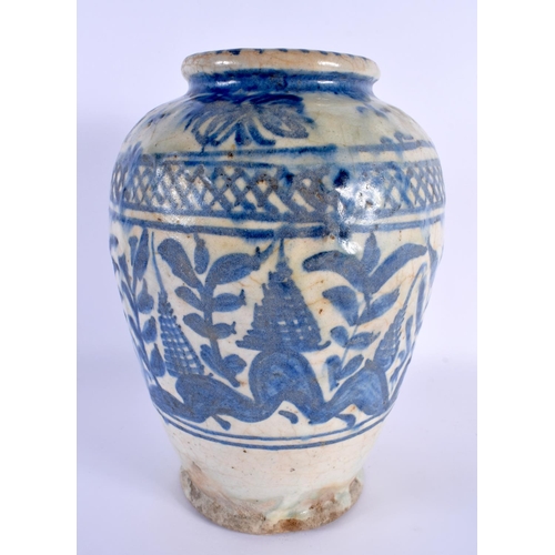 470 - AN EARLY MIDDLE EASTERN PERSIAN BLUE AND WHITE POTTERY VASE painted with foliage and vines. 27 cm x ... 