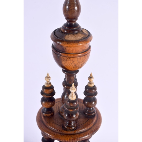 497 - A GEORGE III YEW WOOD LIGNUM VITAE BONE BOBBIN HOLDER. 42 cm x 10 cm.