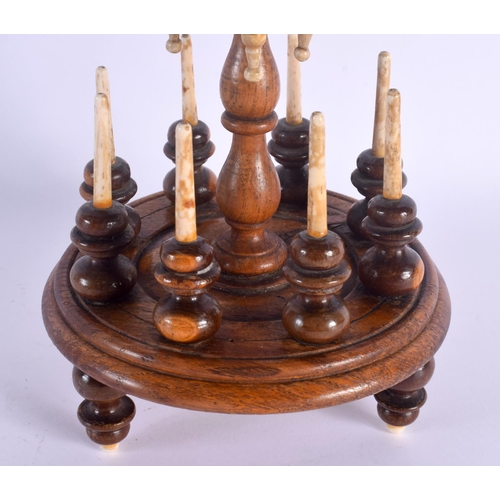 497 - A GEORGE III YEW WOOD LIGNUM VITAE BONE BOBBIN HOLDER. 42 cm x 10 cm.