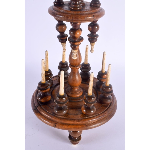 497 - A GEORGE III YEW WOOD LIGNUM VITAE BONE BOBBIN HOLDER. 42 cm x 10 cm.