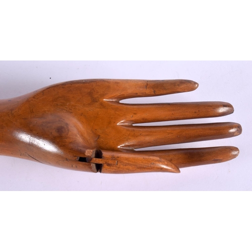 512 - A CHARMING VINTAGE ARTICULATED WOODEN DUMMY HAND possibly for jewellery display. 53 cm long.