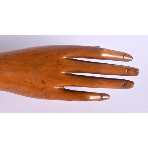 512 - A CHARMING VINTAGE ARTICULATED WOODEN DUMMY HAND possibly for jewellery display. 53 cm long.