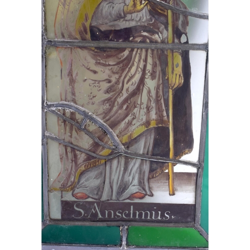 513 - A PAIR OF ANTIQUE STAINED GLASS WINDOWS. 42 cm x 30 cm.