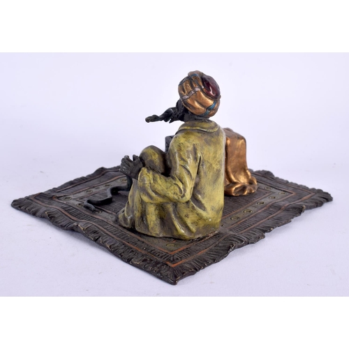 550 - A CONTEMPORARY COLD PAINTED BRONZE SNAKE CHARMER. 14 cm x 11 cm.