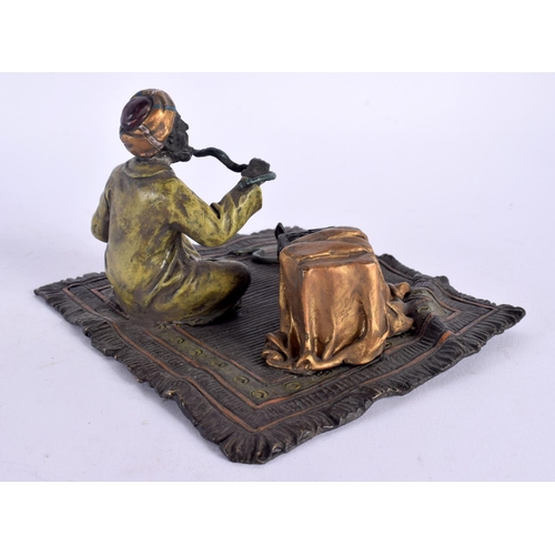 550 - A CONTEMPORARY COLD PAINTED BRONZE SNAKE CHARMER. 14 cm x 11 cm.