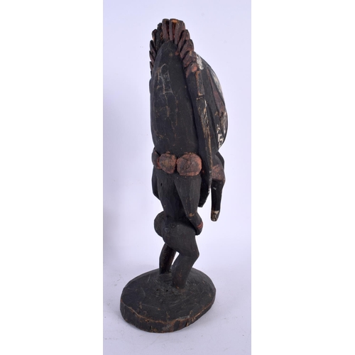 555 - A VINTAGE PAPUA NEW GUINEA CARVED WOOD FIGURE. 33 cm high.