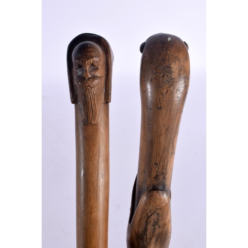 583 - TWO ANTIQUE FOLK ART WALKING CANES. 90 cm long. (2)