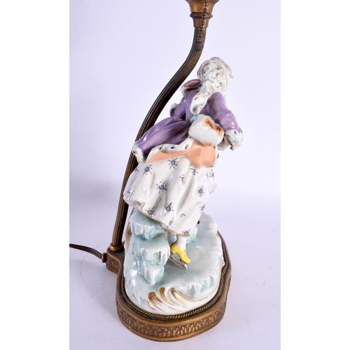 61 - A CONTINENTAL PORCELAIN FIGURAL LAMP. 44 cm high.