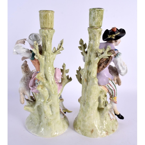 65 - A PAIR OF ANTIQUE PORCELAIN CANDLESTICKS. 27 cm high.