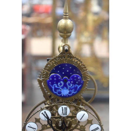 664 - A LARGE CONTEMPORARY ENAMELLED MOON PHASE SKELETON CLOCK. 54 cm x 28 cm.