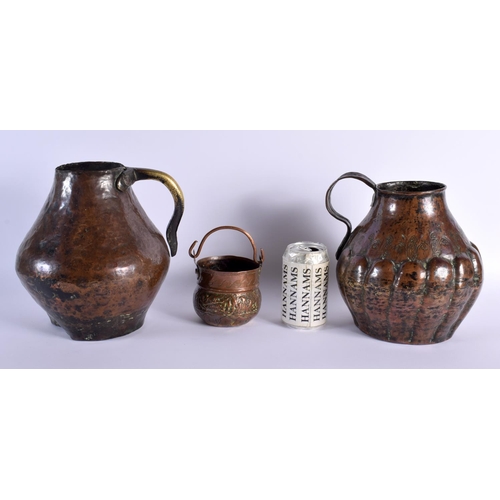 690D - A 17TH/18TH CENTURY MIDDLE EASTERN ISLAMIC COPPER ALLOY JUG together with another similar and a swin... 