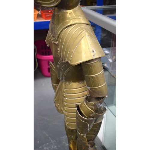 697 - AN UNUSUAL EARLY 20TH CENTURY EUROPEAN BRASS CHILD SIZE SUIT OF ARMOUR. 125 cm high.