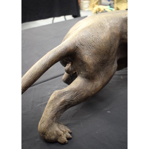 699 - A LARGE CONTEMPORARY BRONZE FIGURE OF A PANTHER modelled in a roaming stance. 100 cm x 30 cm.