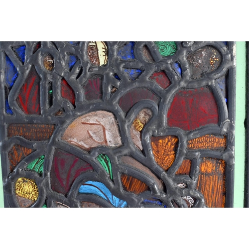 708 - AN UNUSUAL STAINED GLASS WINDOW depicting figures in erotic pursuits. 26 cm x 18 cm.