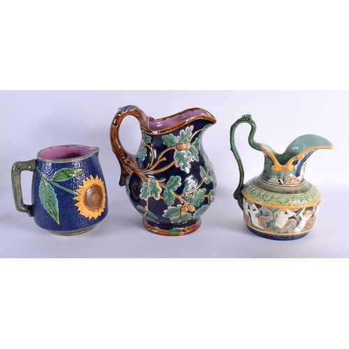 71 - THREE LARGE MAJOLICA JUGS. Largest 25 cm x 18 cm. (3)