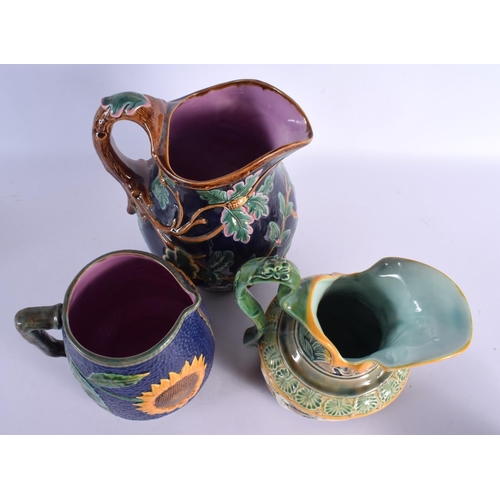 71 - THREE LARGE MAJOLICA JUGS. Largest 25 cm x 18 cm. (3)