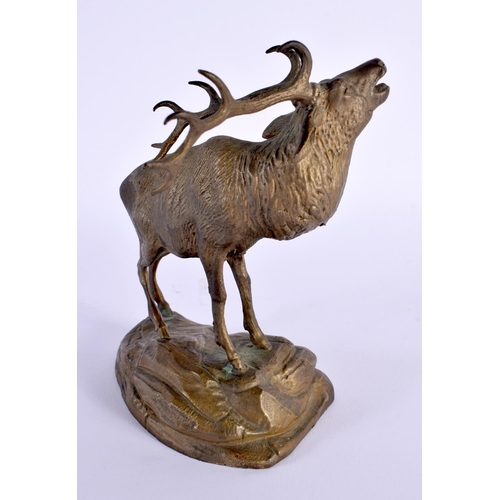 710D - AN EARLY 20TH CENTURY EUROPEAN BRONZE FIGURE OF A STAG modelled upon a rocky outcrop. 15 cm x 10 cm.