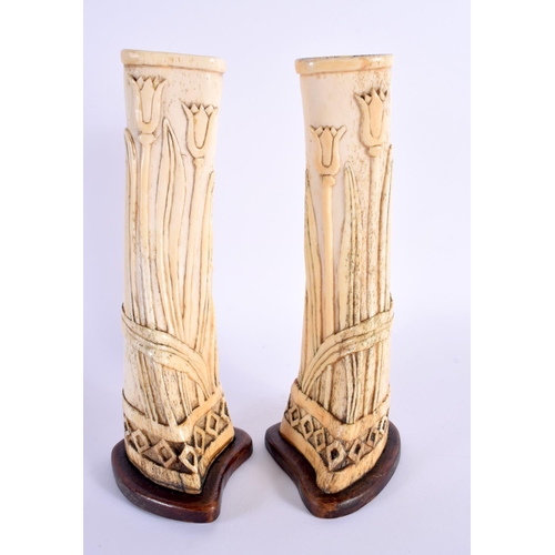 710E - A PAIR OF 19TH CENTURY CONTINENTAL PRISONER OF WAR CARVED BONE VASES of organic form. 23.5 cm high.