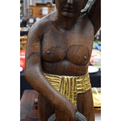 723E - A LARGE 1930S CARVED AND PAINTED OAK FIGURE possibly from a fair ground. 100 cm x 15 cm.