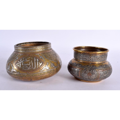 726 - TWO 19TH CENTURY MIDDLE EASTERN SILVER INLAID CENSERS decorated with calligraphy. Largest 11 cm wide... 