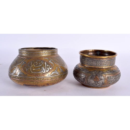 726 - TWO 19TH CENTURY MIDDLE EASTERN SILVER INLAID CENSERS decorated with calligraphy. Largest 11 cm wide... 