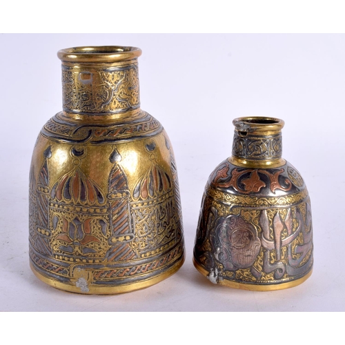 727 - A RARE 19TH CENTURY MIDDLE EASTERN SILVER INLAID BOTTLE NECK VASE decorated with buildings, together... 