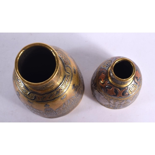 727 - A RARE 19TH CENTURY MIDDLE EASTERN SILVER INLAID BOTTLE NECK VASE decorated with buildings, together... 