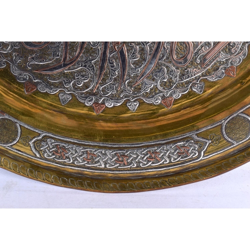 729 - A LARGE 19TH CENTURY MIDDLE EASTERN SILVER INLAID CIRCULAR PLATE decorated with a floral motif encas... 