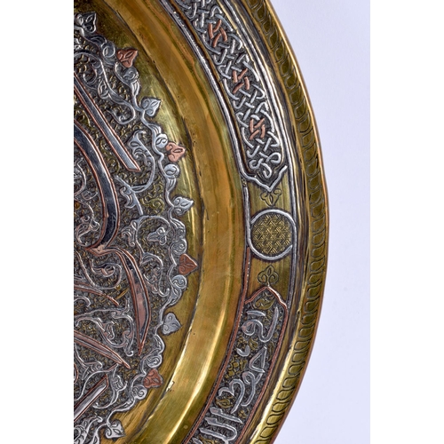 729 - A LARGE 19TH CENTURY MIDDLE EASTERN SILVER INLAID CIRCULAR PLATE decorated with a floral motif encas... 