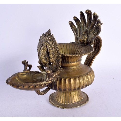 739 - AN UNUSUAL 18TH/19TH CENTURY INDIAN BRONZE HOLY OIL VESSEL formed with Ganesha behind a flaming term... 