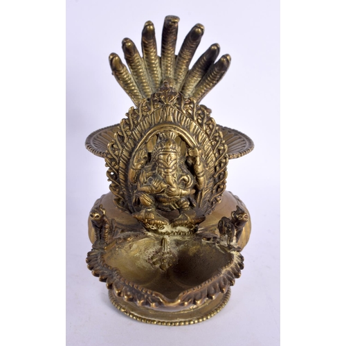 739 - AN UNUSUAL 18TH/19TH CENTURY INDIAN BRONZE HOLY OIL VESSEL formed with Ganesha behind a flaming term... 