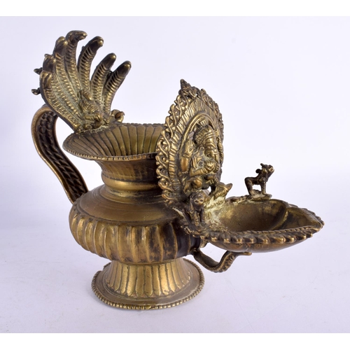 739 - AN UNUSUAL 18TH/19TH CENTURY INDIAN BRONZE HOLY OIL VESSEL formed with Ganesha behind a flaming term... 