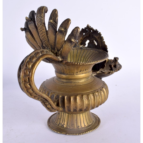 739 - AN UNUSUAL 18TH/19TH CENTURY INDIAN BRONZE HOLY OIL VESSEL formed with Ganesha behind a flaming term... 